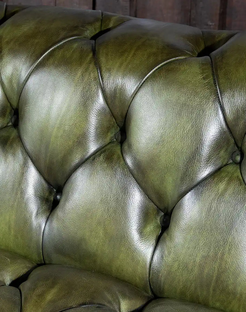 Close-up of button tuftings, adding a touch of sophistication to the leather sofa.