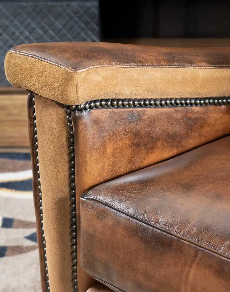 Focus on the sueded arm panels of the Vlad Brown Leather Recliner, adding texture and contrast to the design.