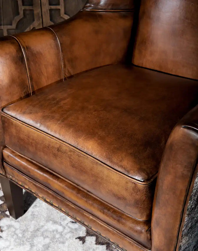 A close-up of the Westlife Leather Chair’s plush leather cushion, offering firm support and luxurious comfort.