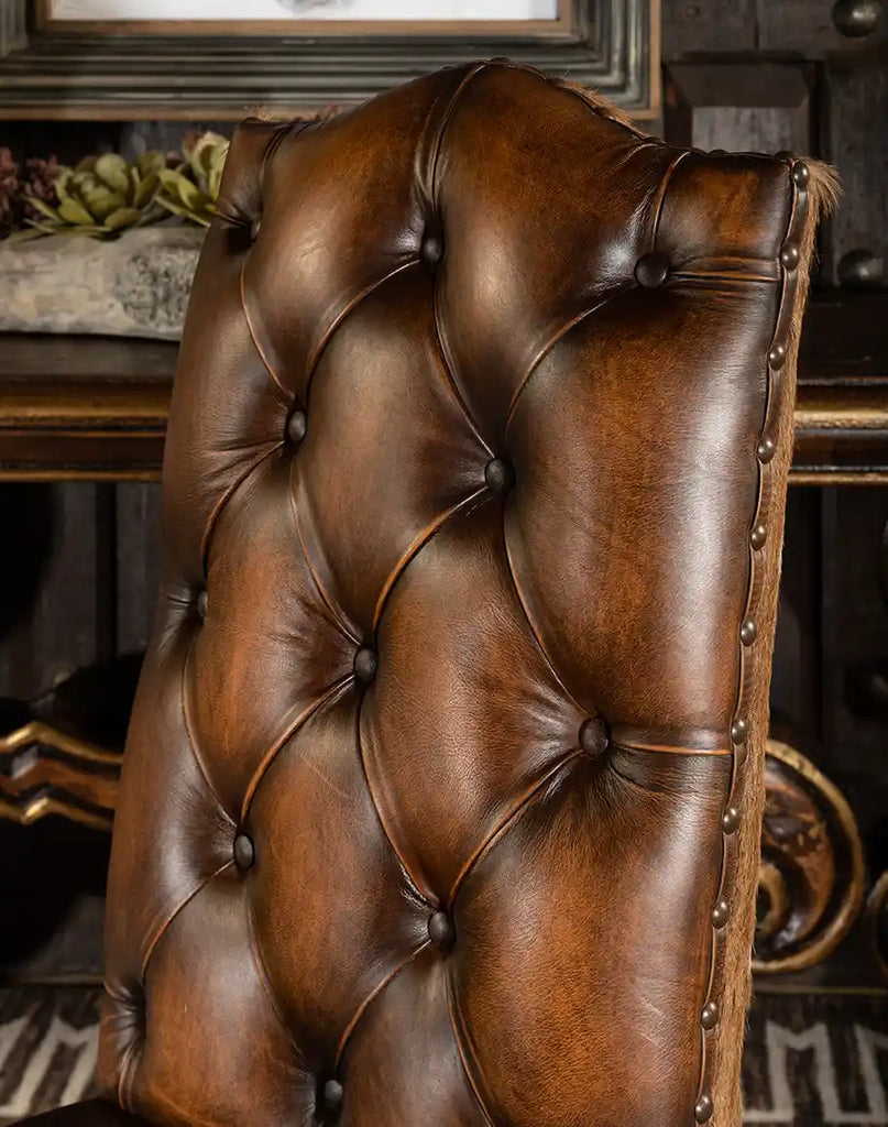 Close-up of the deep button tufted seat back on the Westwood Axis Hide Dining Chair, emphasizing its luxurious comfort and craftsmanship.