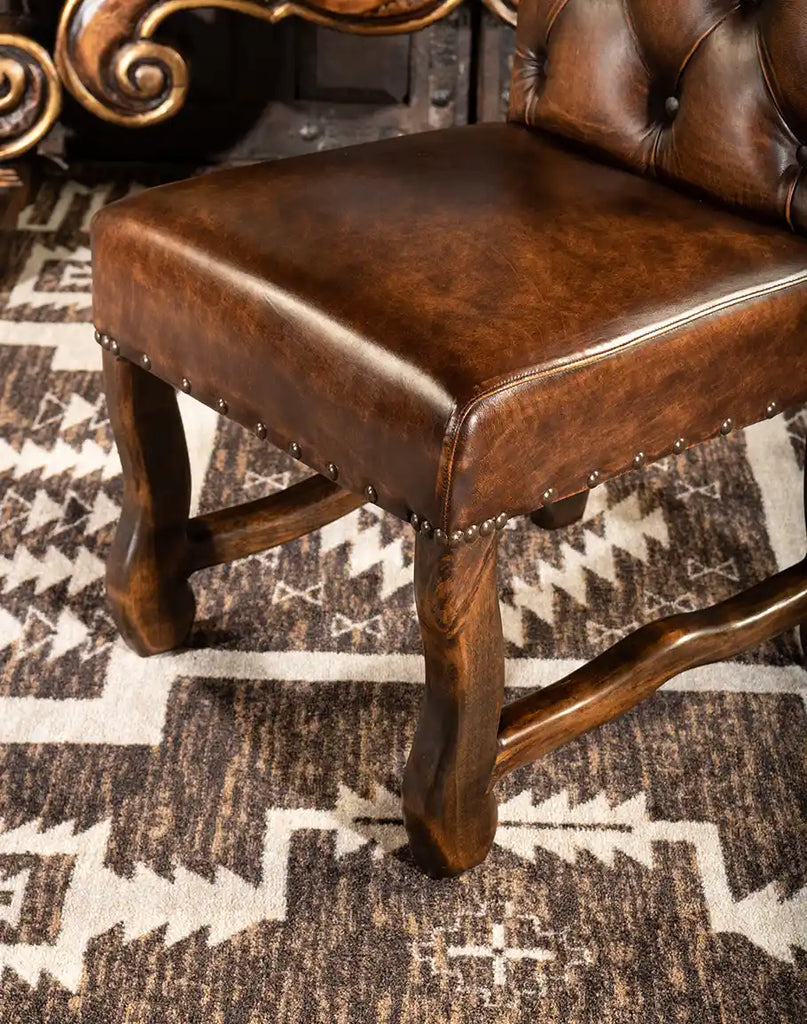 Detailed view of the Knotty Alder hardwood leg on the Westwood Axis Hide Dining Chair, showcasing its sturdy craftsmanship and natural wood grain.