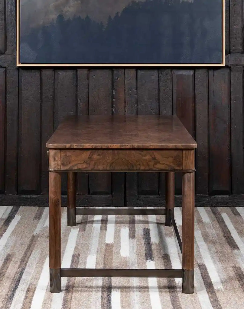 A side-angle view of the Whitman Writer’s Desk, highlighting its sturdy construction and smooth, polished wood grain.