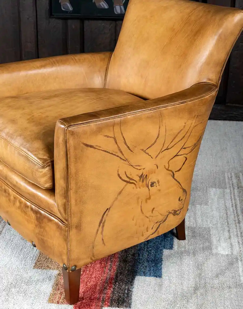 A detailed close-up of the hand-burnished leather texture on the Wild Elk Leather Chair, emphasizing its artisan craftsmanship.