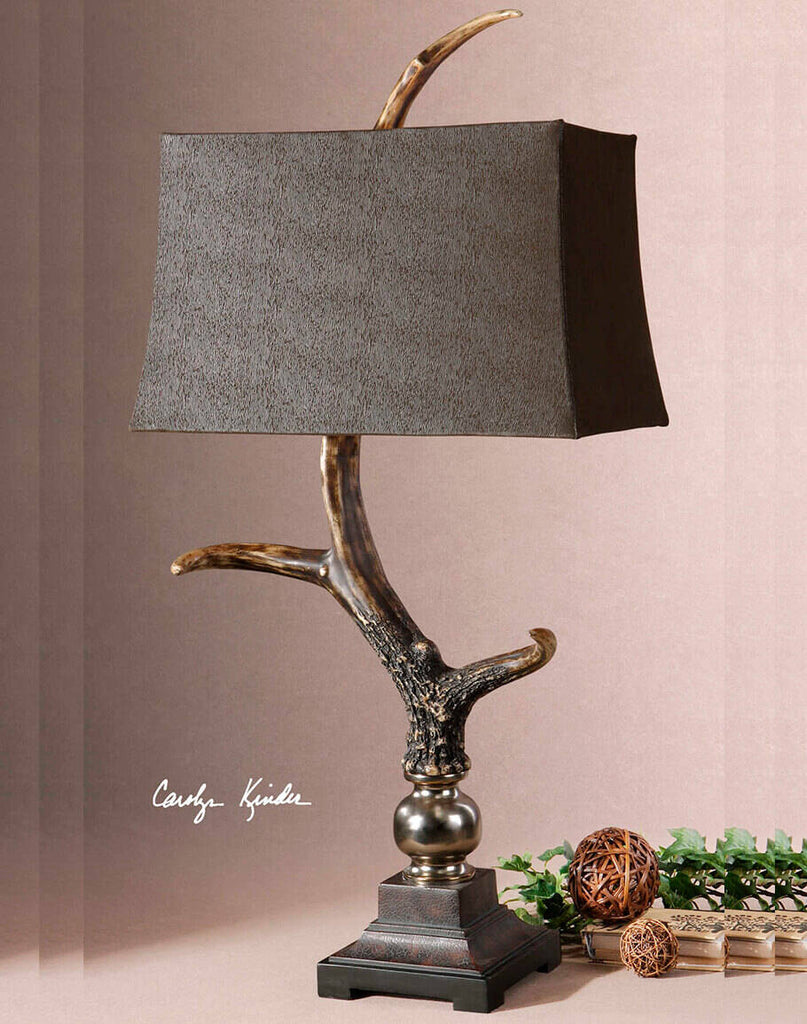 Wild Stag Horn Table Lamp showcasing its burnished bone ivory finish, crackled wood tone base, and rectangle semi-drum shade made of sueded chocolate fabric.