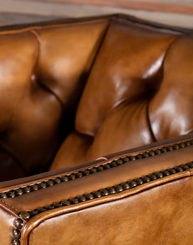 Close-up of the deep button tufting on the Kingston Tufted Leather Chair’s seat and back, emphasizing its timeless craftsmanship.