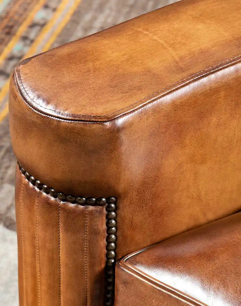 The Yeager Leather Chair with wide, flat armrests, designed for ergonomic comfort and a modern aesthetic.