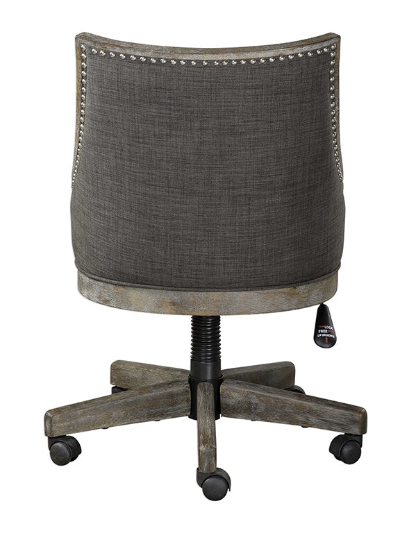 Adrian desk chair designed with an adjustable seat height, polished nickel nailhead detailing, and a curved back upholstered in warm charcoal gray linen.