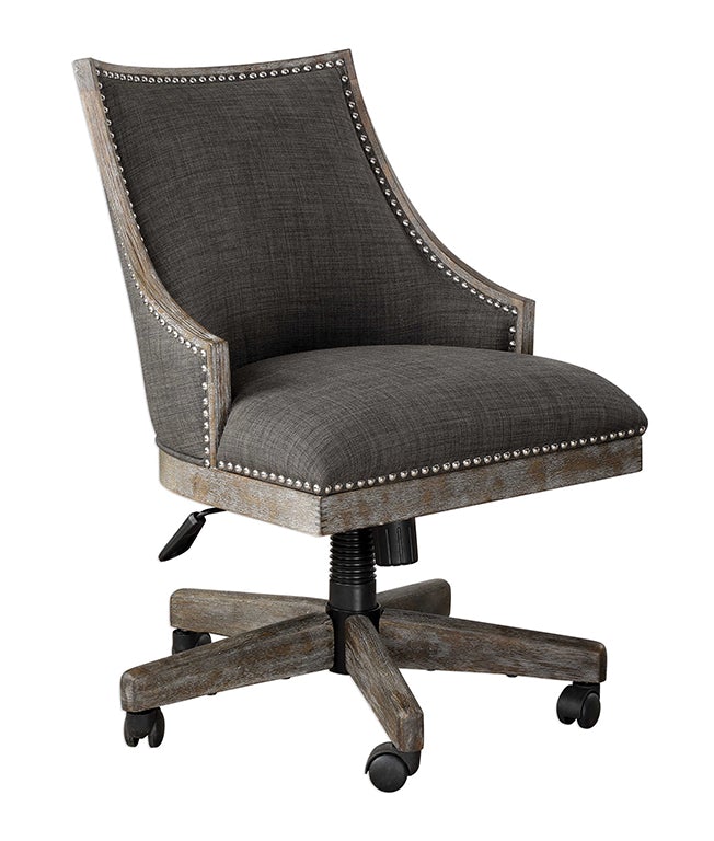 Adrian desk chair featuring a charcoal gray linen back, polished nickel nailhead trim, and adjustable height with a honey-stained, gray-washed wood frame.