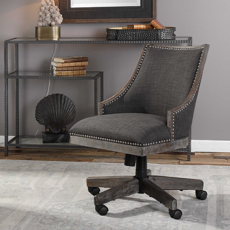 Modern Adrian desk chair featuring luxurious charcoal gray linen upholstery, nickel nailhead trim, and a gray-washed honey-stained adjustable wood frame.